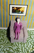 simmons purplewoman graychair greenrug painting